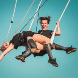 Twee artiesten van het gezelschap Lady Cocktail voeren een spectaculaire luchtacrobatiekact op in de show De la Mort qui Tue.