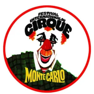 Official logo of the Monte-Carlo International Circus Festival. It depicts a clown's face with a red nose, an orange wig, and a green costume, surrounded by a red circle. The festival's name appears in large black letters above the vis