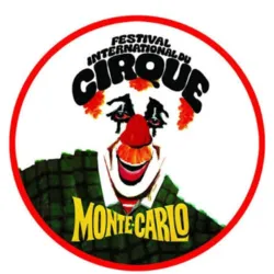 Official logo of the Monte-Carlo International Circus Festival. It depicts a clown's face with a red nose, an orange wig, and a green costume, surrounded by a red circle. The festival's name appears in large black letters above the vis