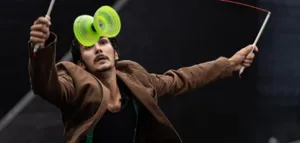 Yohan Durand in full diabolo performance with two sticks, performing a spectacular figure during his juggling, dance and theatre show "It's silly but it sticks to the skin".