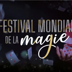 Official visual of the World Magic Festival showing a magician making playing cards fly in a dark and bright setting, with the event logo in the foreground.
